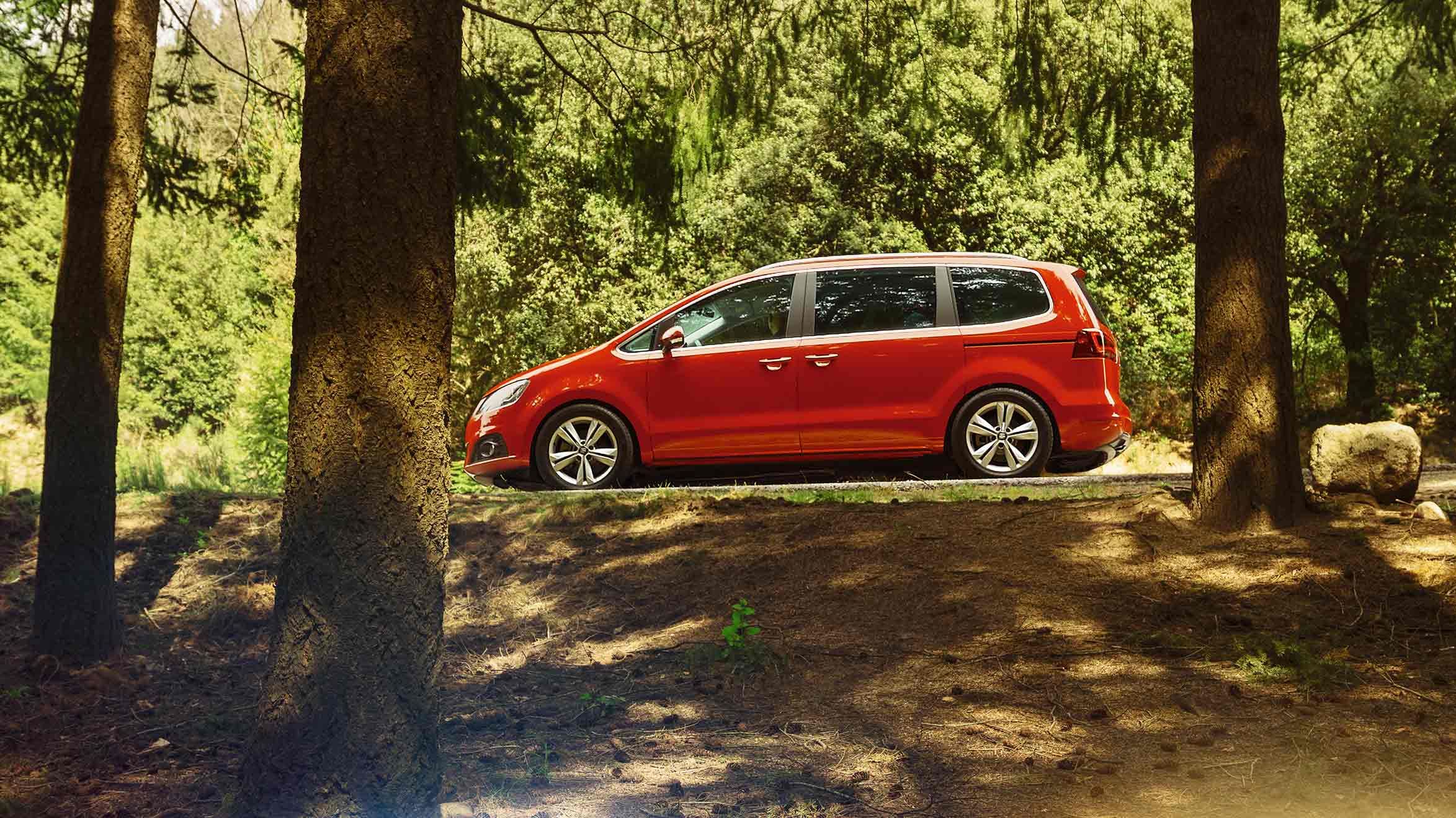 Ein roter SEAT Alhambra steht in der Einfahrt eines Wohnhauses