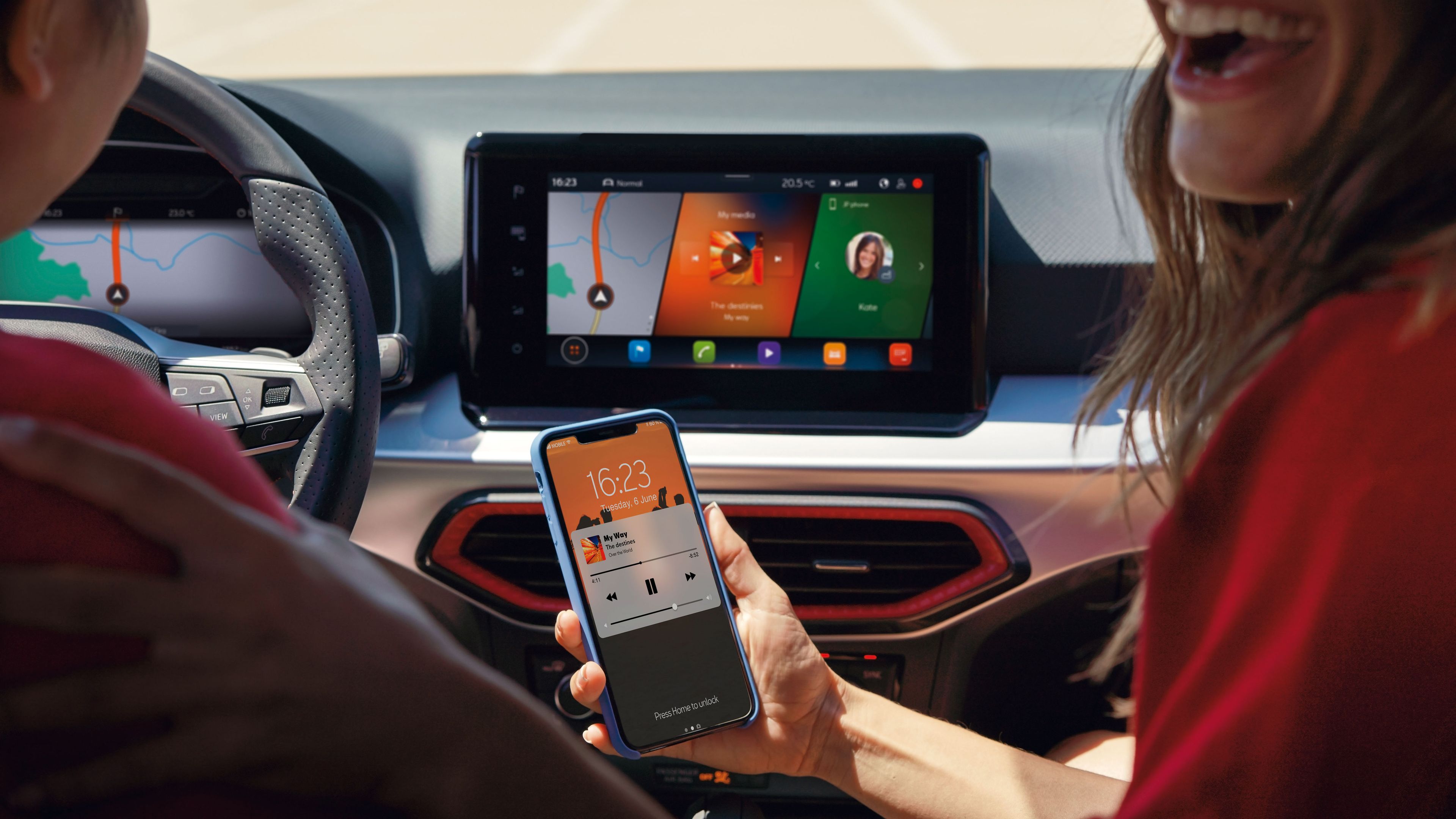 Eine Frau sitzt auf dem Beifahrersitz eines SEAT Ibiza, hält ihr Smartphone in der Hand und nutzt SEAT Connect. Sie dreht sich zur Rückkamera und lacht, während sie das Handy zeigt