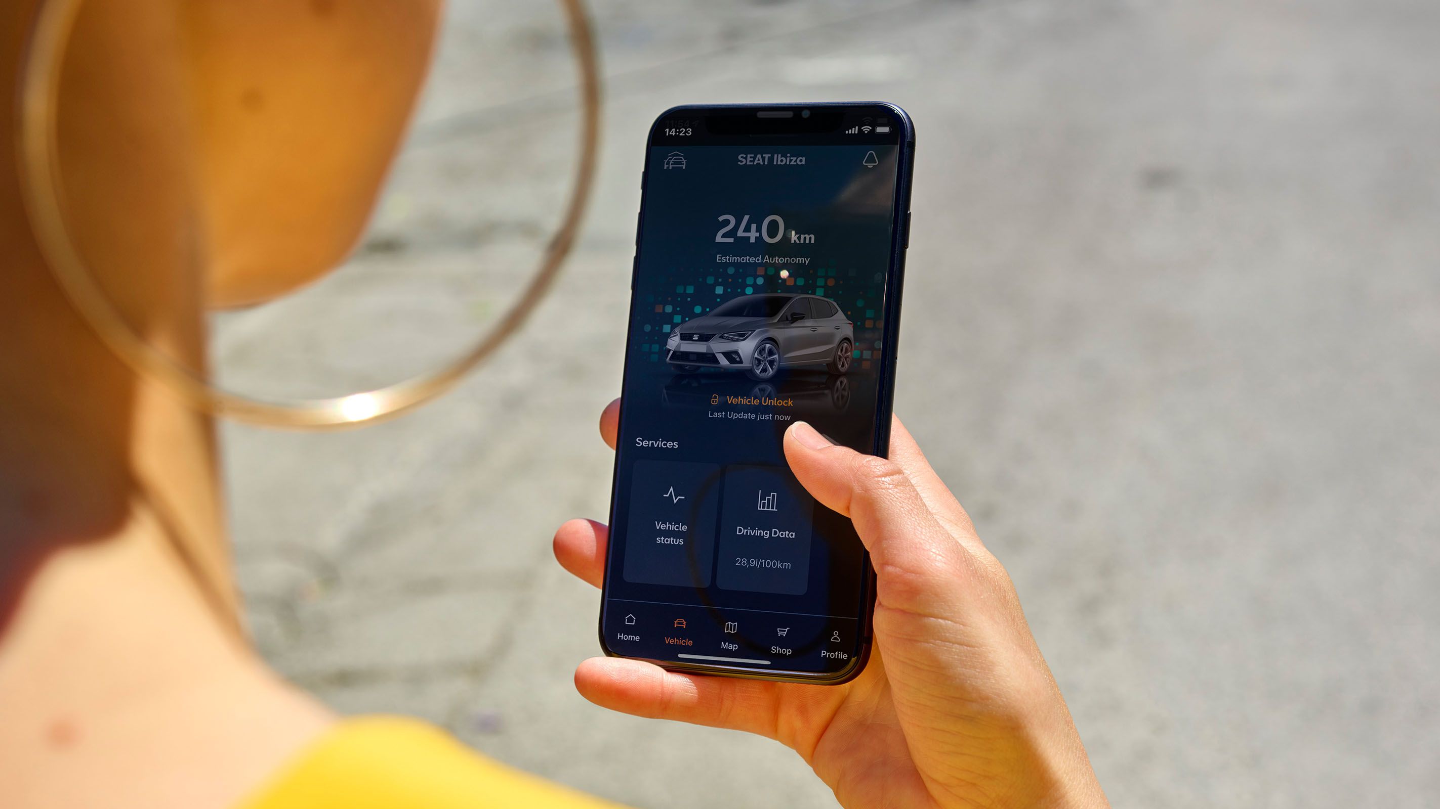 Frau schaut auf ihr Handy und verwendet SEAT Connect